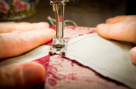 woman at a sewing machine - two hands